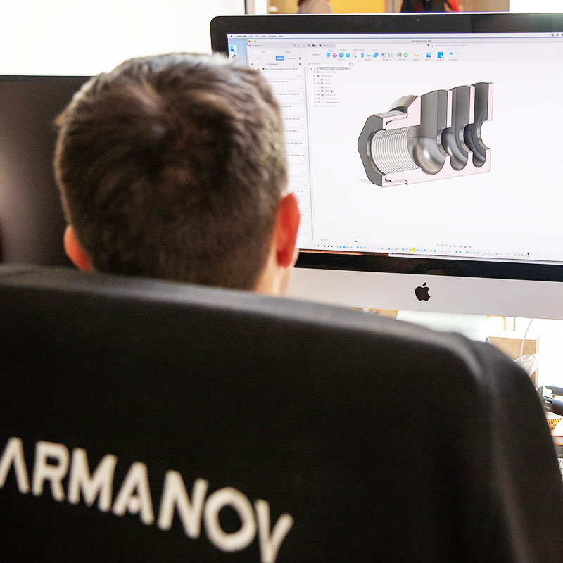 Armanov engineer working on CAD/CAM product design for shooting accessories