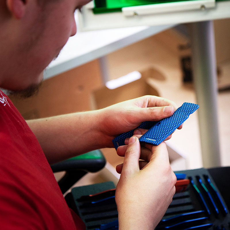 Armanov quality control inspector checking shooting gear before shipping